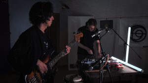 Holy Tongue perform at East London Studio, Arcus Sounds, the performers on bass and electronics are visible
