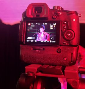 Musician on camera at a live session at the content creator studio